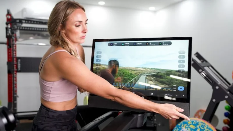 GGR Everything lead reviewer Lindsay Scheele pivots the touchscreen on the NordicTrack Commercial 2450 treadmill