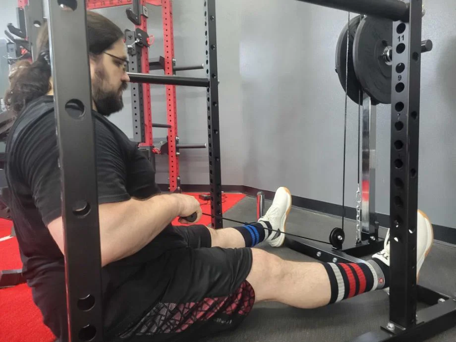 olympian caine wilkes using a giant lifting garage gym power rack with lat low row