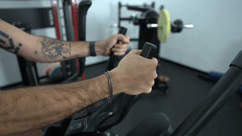 Our tester gripping the stationary handlebars found on the Bowflex Max Trainer M6