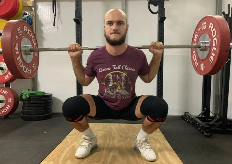 Man performing a barbell back squat