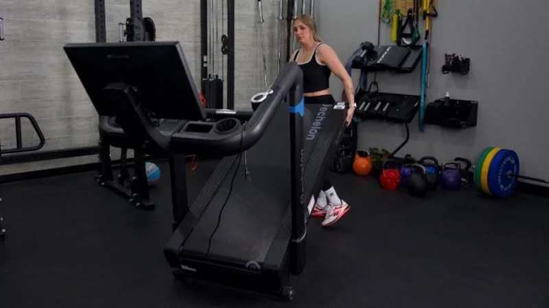 A person folding the Echelon Stride 8s treadmill.