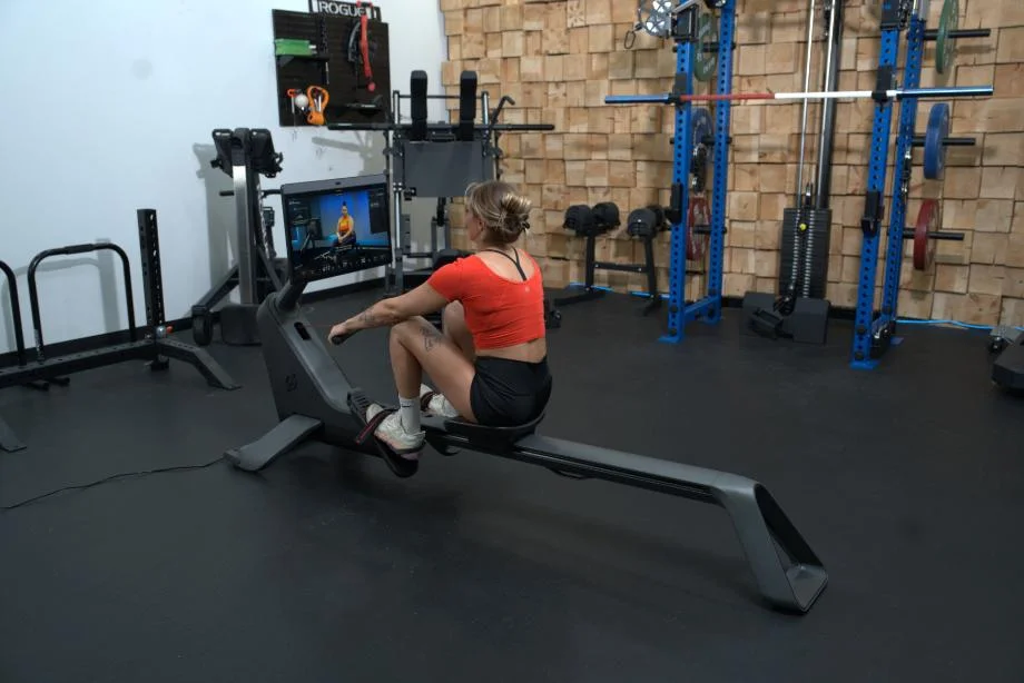 Woman rowing on the Peloton Row for the Peloton Row review