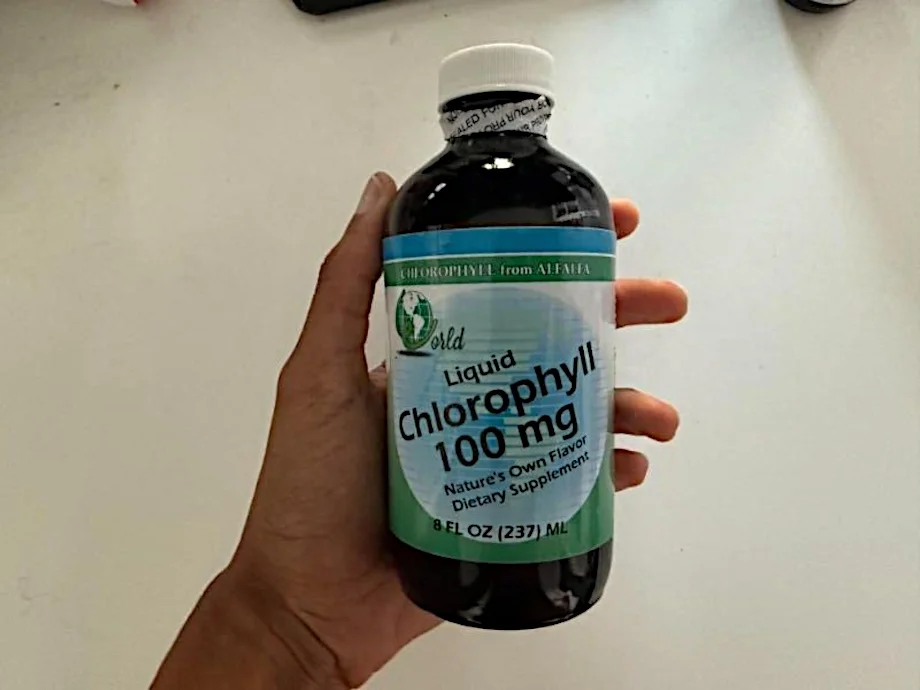 Our tester holds up a bottle of World Organic Liquid Chlorophyll