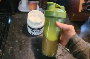 holding a shaker of transparent labs intra bcaas 2
