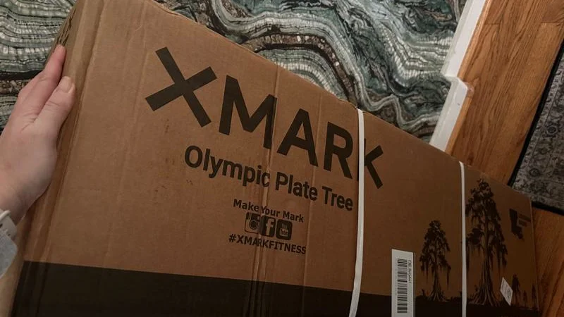 Our tester unboxing the XMARK Olympic Plate Tree.
