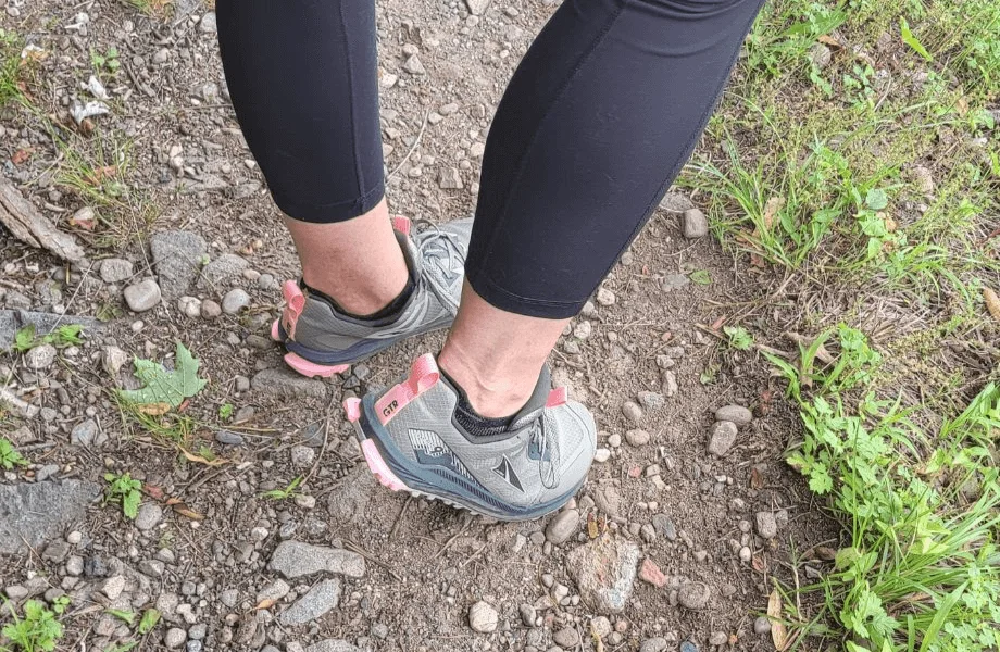 Our tester standing on a trail in the Altra Lone Peak 9 trail running shoes