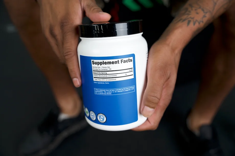 Product tester showing the supplement facts label on a container of Nutricost Creatine