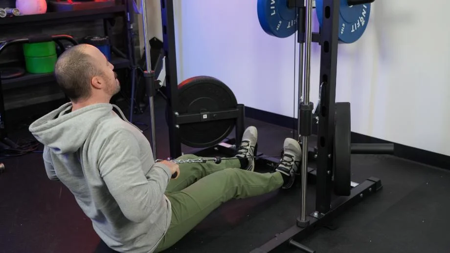Coop does a low row on the RitFit Smith Machine.