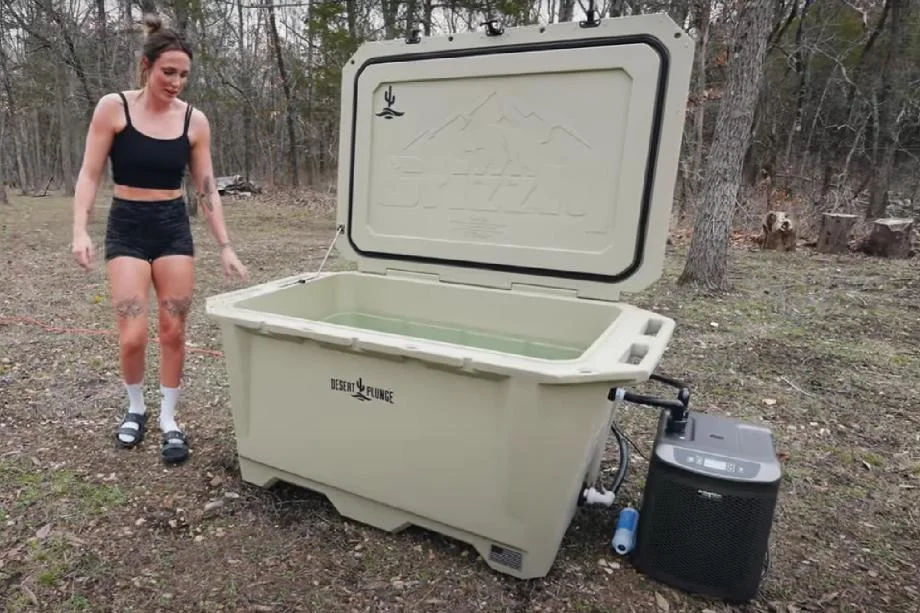 A woman about to step into and use the Desert Cold Plunge Tub