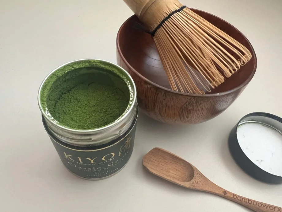 Looking down on a ceremonial matcha setup with an opened tin of Kiyo Ceremonial Matcha