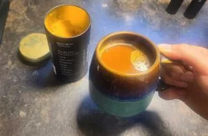 holding mug of mudwtr