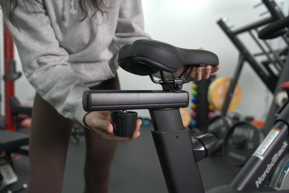 Adjusting the seat on a NordicTrack X24 Bike.
