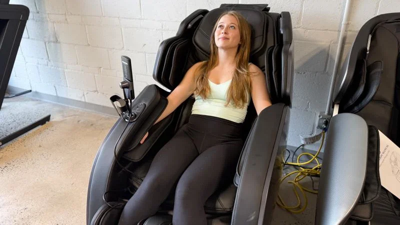 A product tester relaxing in the Bob and Brad Massage Chair