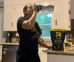 person drinking ascent protein