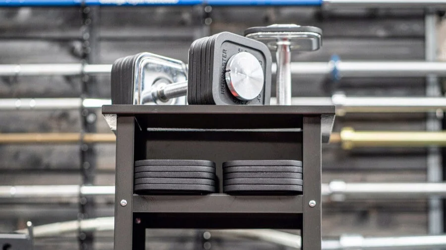 Ironmaster dumbbells on a dumbbell stand with weights