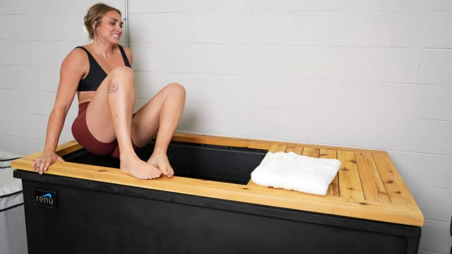 How to cold plunge: Woman getting in the Renu Therapy Cold Stoic tub
