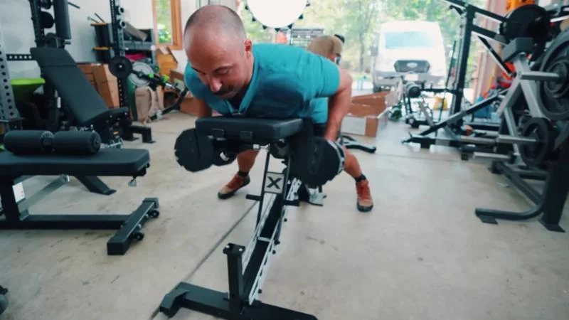 Coop performing chest-supported rows on the Freak Athlete ABX Weight Bench