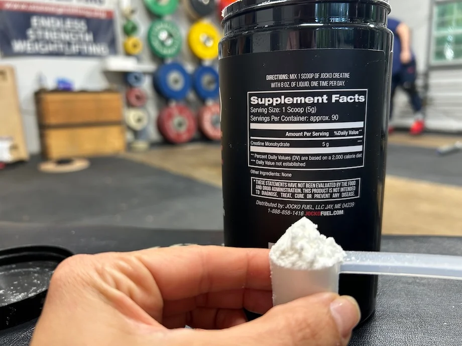 Person holding a scoop of Jocko Creatine