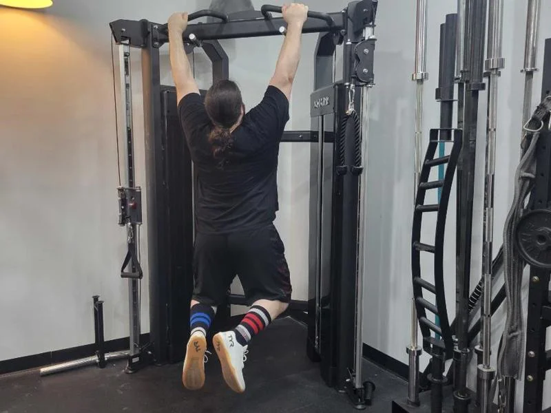 Caine doing pull-ups on the XMark Functional Trainer.
