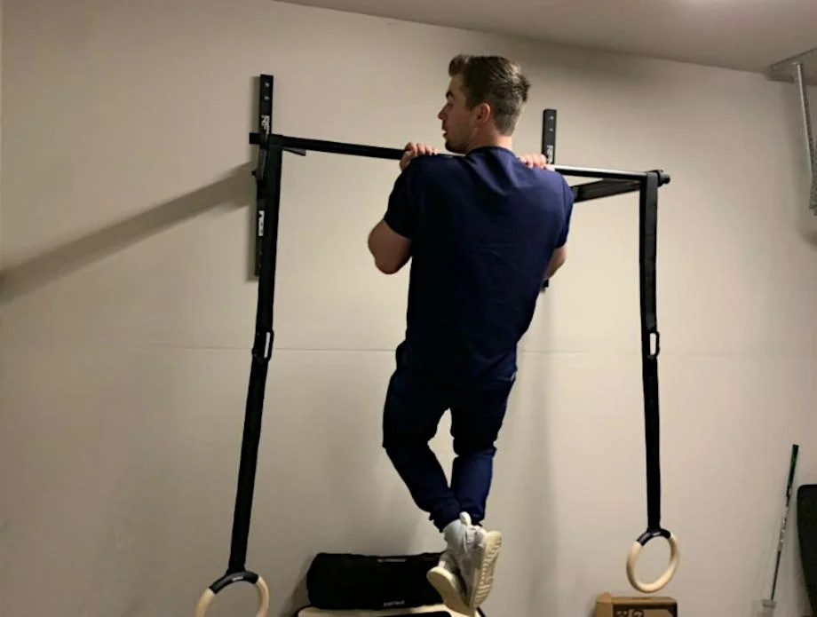 A man using the RPM Atom Pull-up Bar