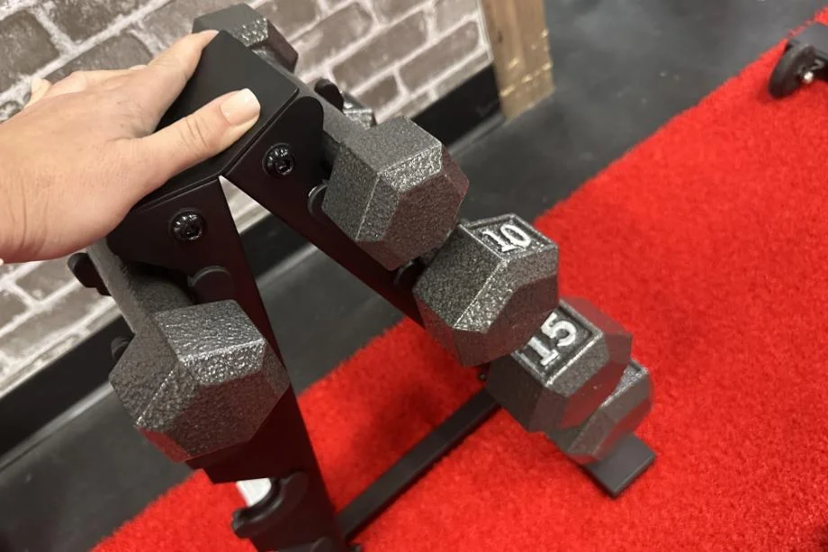 Looking down at a rack of different weighted Cap Iron Hex Dumbbells.