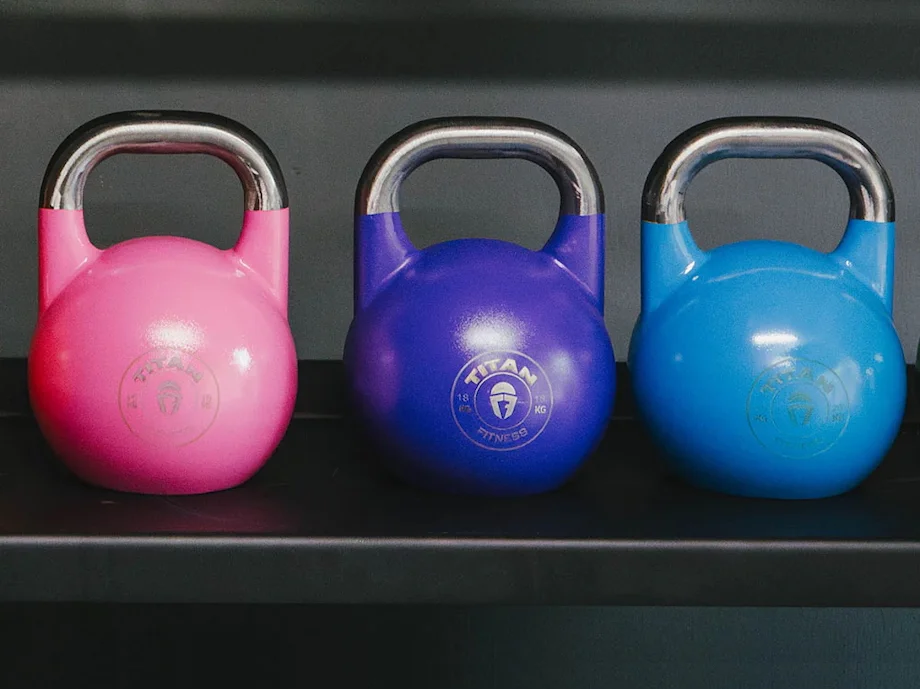 Multiple Titan Fitness Competition Style Kettlebells lined up next to each other
