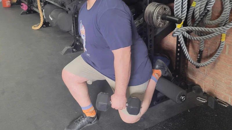 Our tester using the REP Fitness 5000 Series Leg Roller Attachment