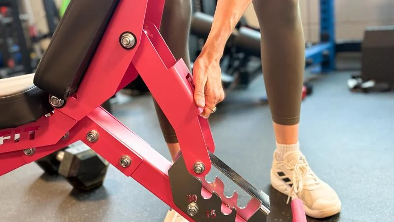A person adjusts the backrest on the Ritfit Gator Bench.