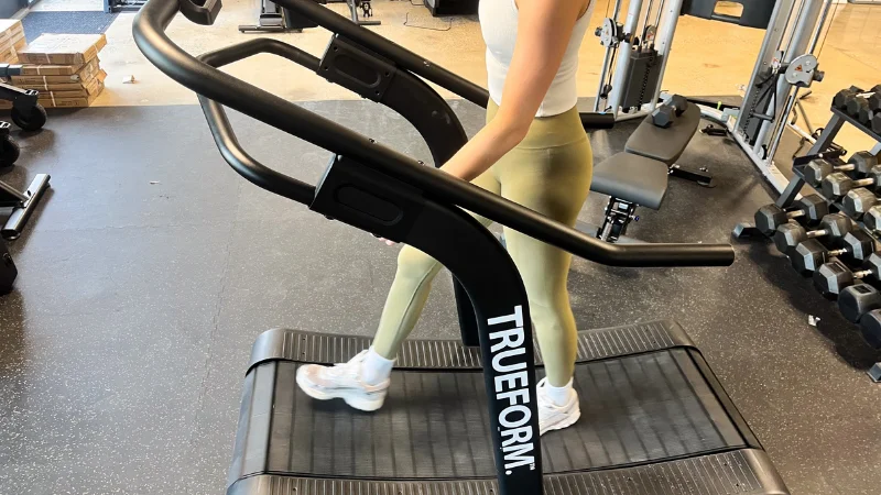 Side view of our tester using the TrueForm Trainer manual treadmill