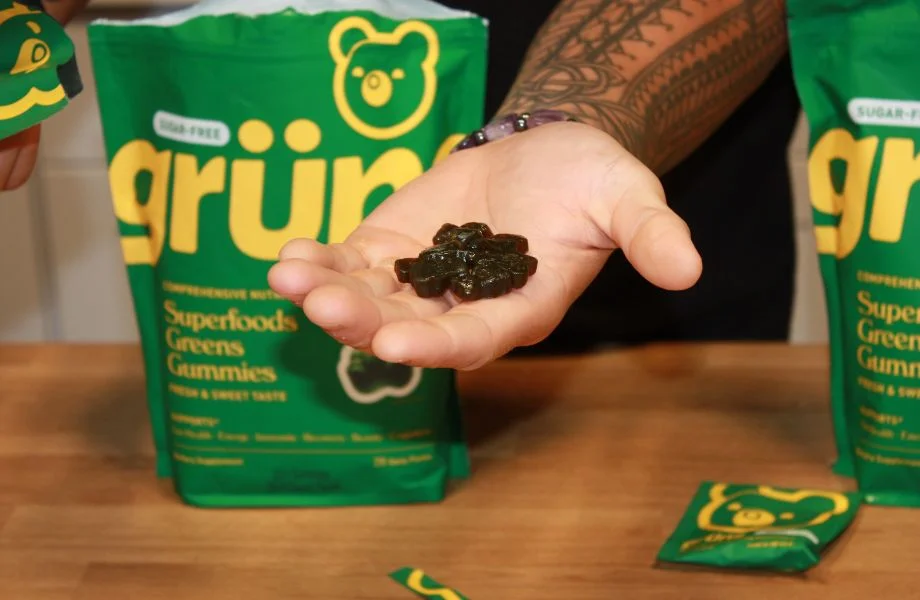 Person holding Grüns gummies in his hand