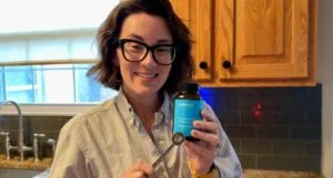 person holding bioniq go multivitamin jar