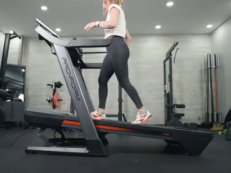A woman walking on the ProForm Pro 2000 treadmill on an incline
