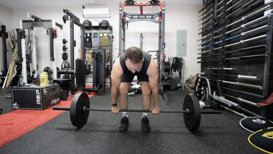 Coop setting up for a deadlift in a garage gym.