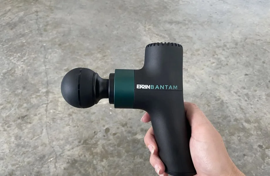 holding the Ekrin Athletics BANTAM mini massage gun