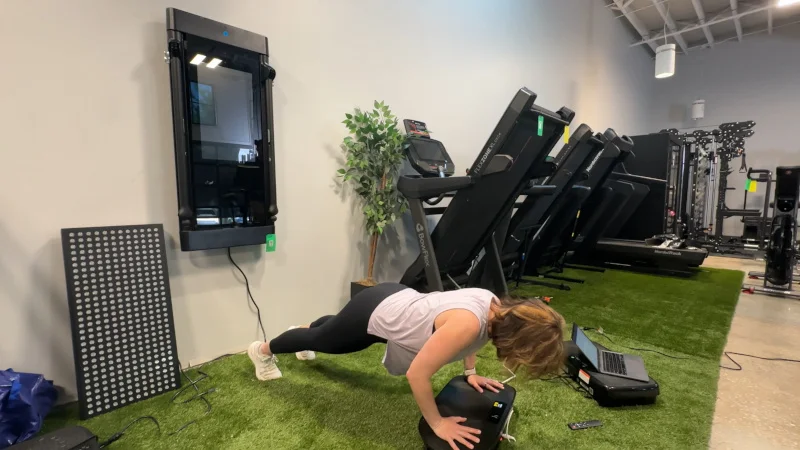 Our tester doing push ups on a Merach CV30 Vibration Plate.