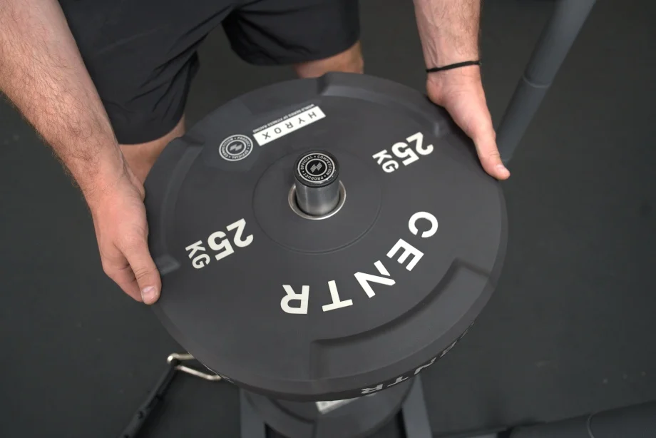Our tester loads a sled with a Centr x HYROX Competition Edge Bumper Plate