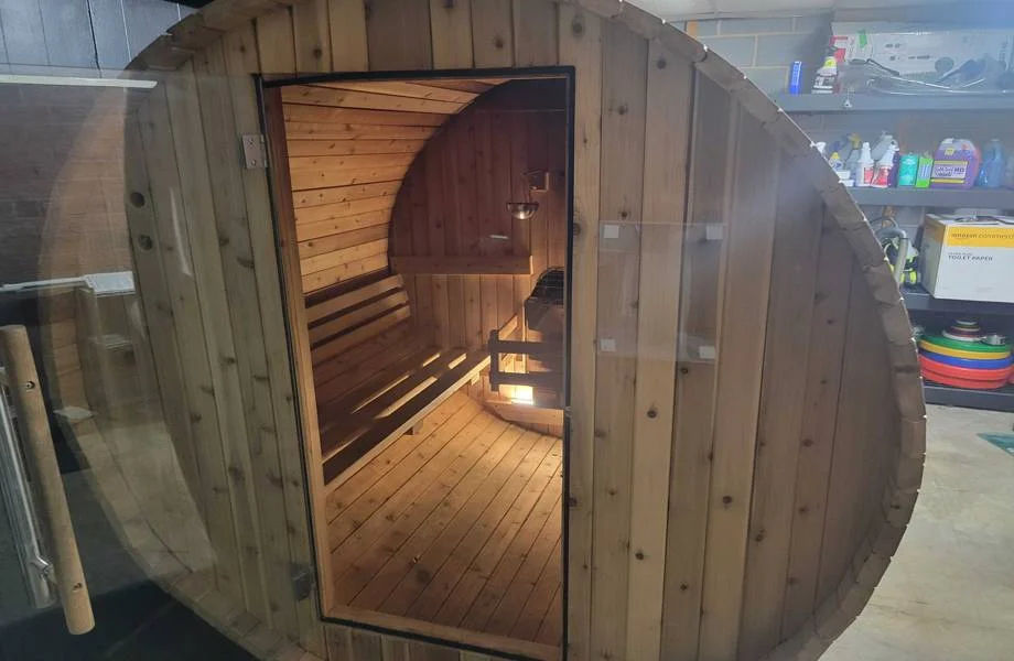 exterior view of almost heaven morgan barrel sauna located inside a garage