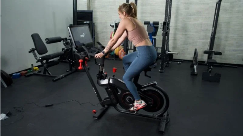woman riding bowflex velocore exercise bike