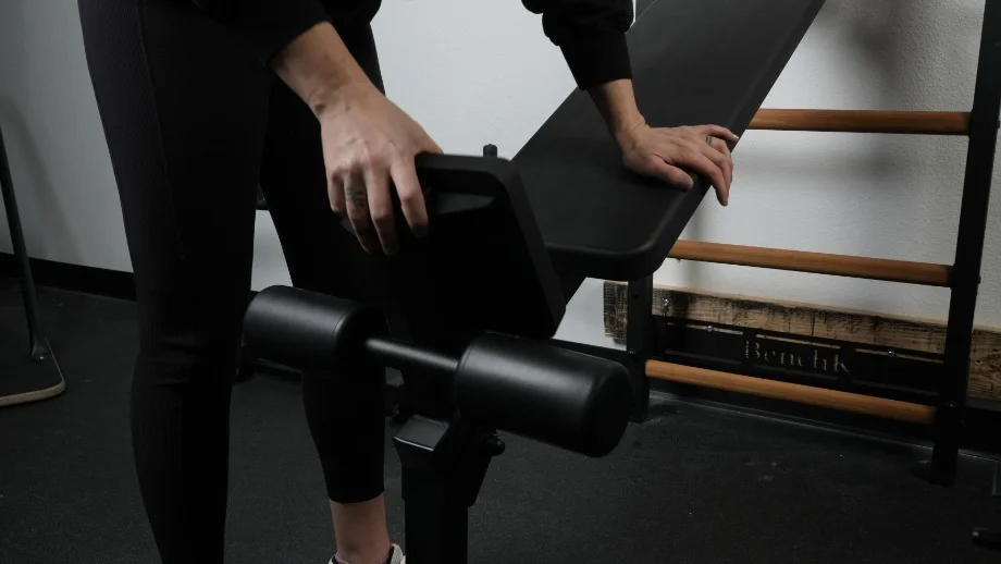 A person adjusts the BenchK Wall Bars.
