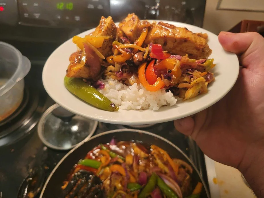 A hand holds a meal made with meat from Good Ranchers.