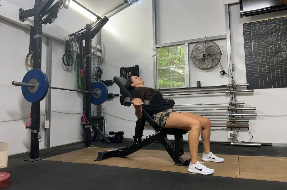 Woman lifting weighs on a Force USA Pro Series FID Bench