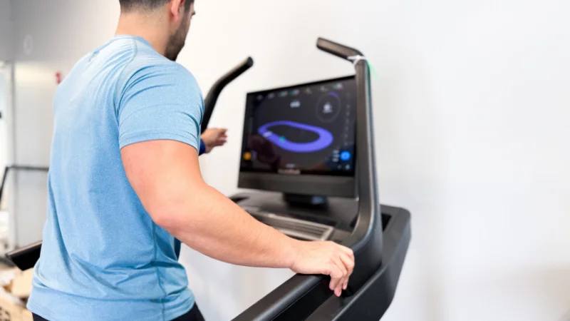 Our tester demonstrating the HD touchscreen display on the NordicTrack X24 treadmill