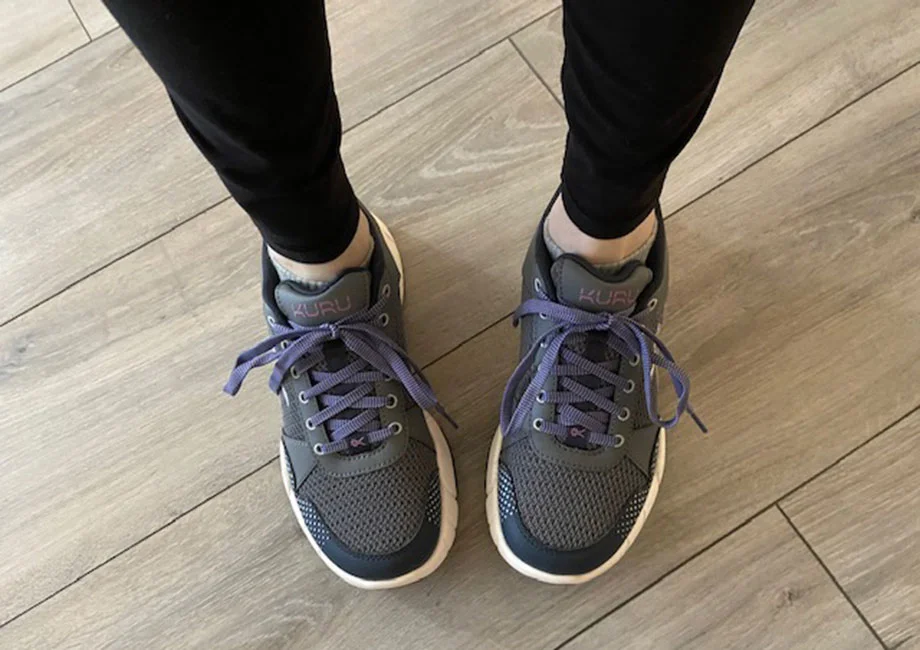 Looking down on a pair of feet wearing a pair of KURU QUANTUM 2.0 shoes.