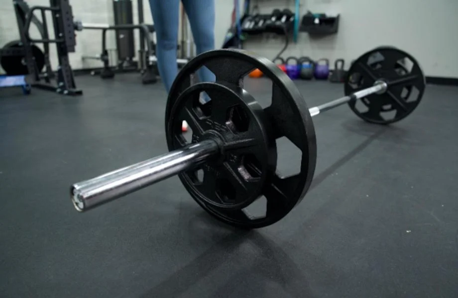 Side view of the Major Fitness Barbell on a gym floor