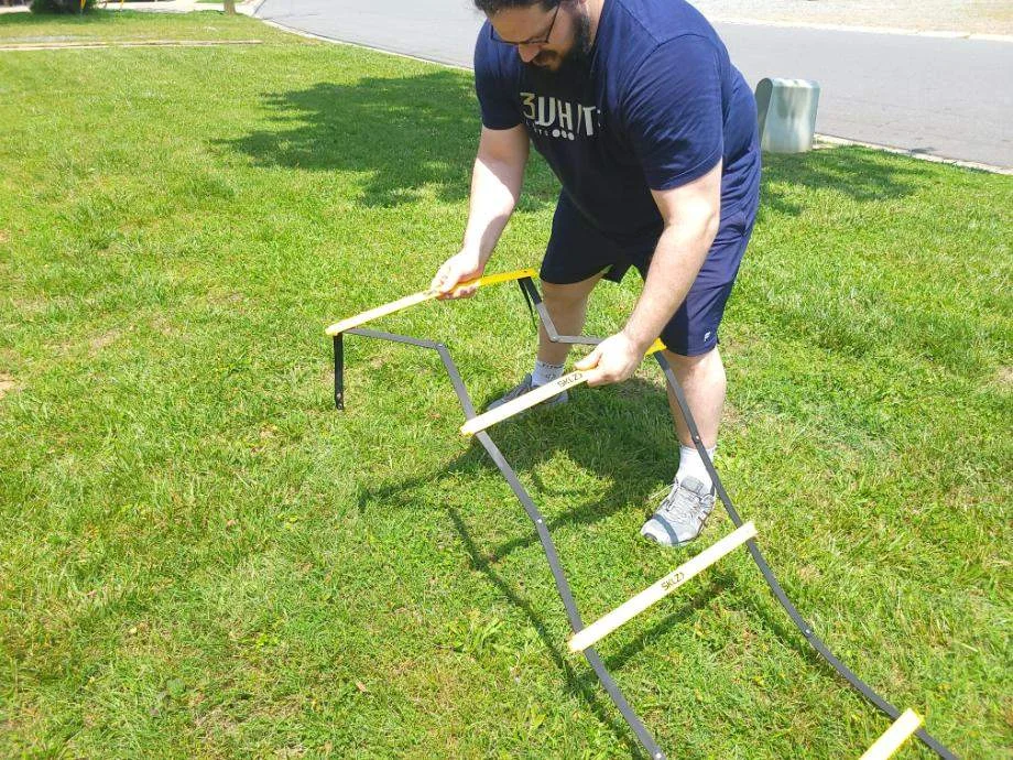 Olympian Caine Wilkes unfolds the SKLZ Quick Ladder Pro.