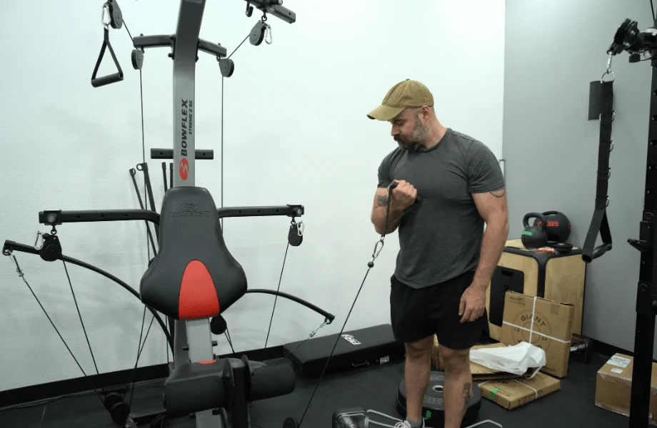 Our tester performing a biceps curl with the Bowflex Xtreme 2 SE Home Gym