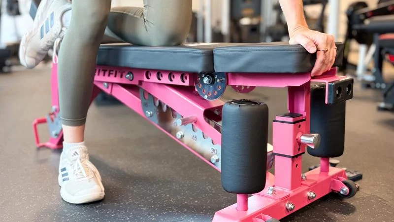 A person lifting weights on Ritfit Gator Bench.