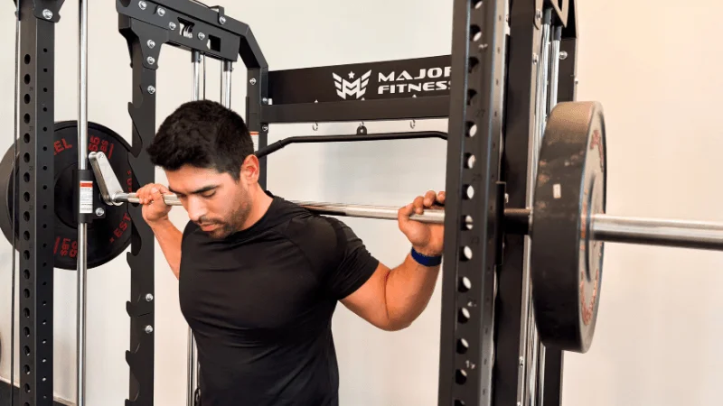 Our tester unracking the Major Fitness B52 Pro's Smith machine barbell for a training set