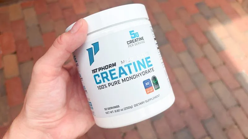 tester holding a tub of 1st phorm micronized creatine monohydrate 1