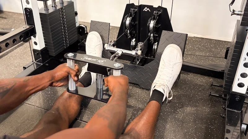 Product tester performs a seated row on the REP Fitness Altitude Power Rack